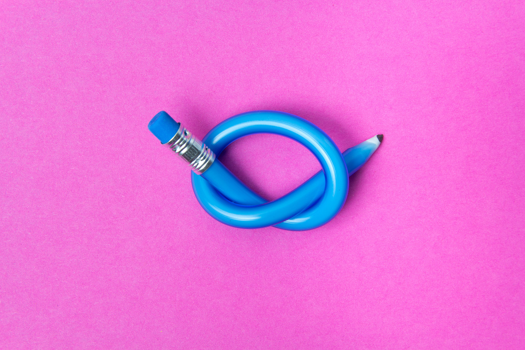 Flexible pencil on pink background. Bent pencils. Flexible business concept.